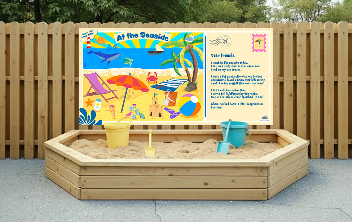 Seaside-themed learning board showing a beach scene with sea creatures, sandcastles and a descriptive post card message for children.